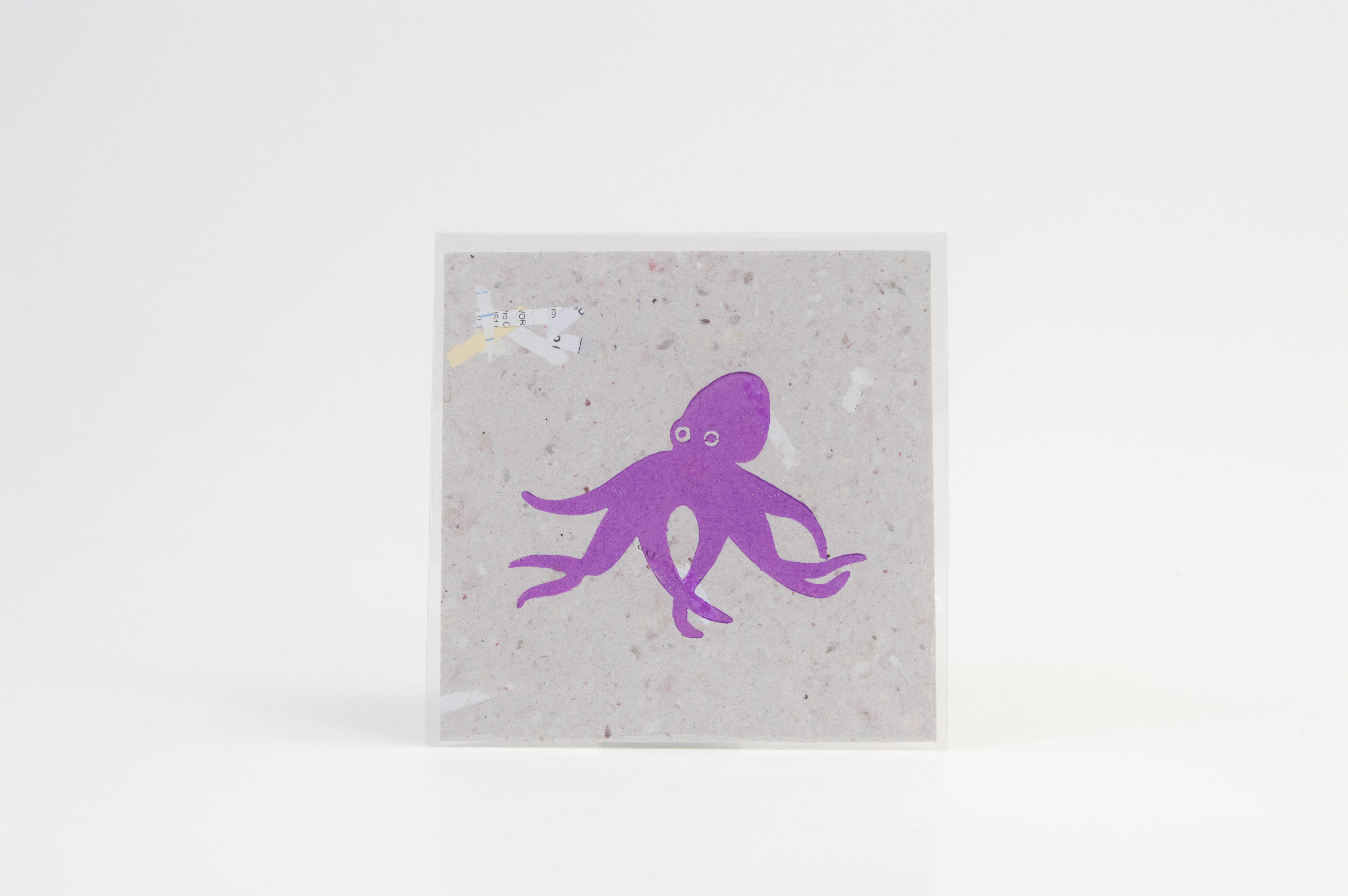 A relief print of a purple octopus.